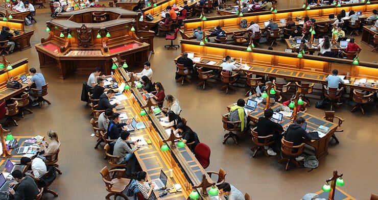 Students studying in a large hall